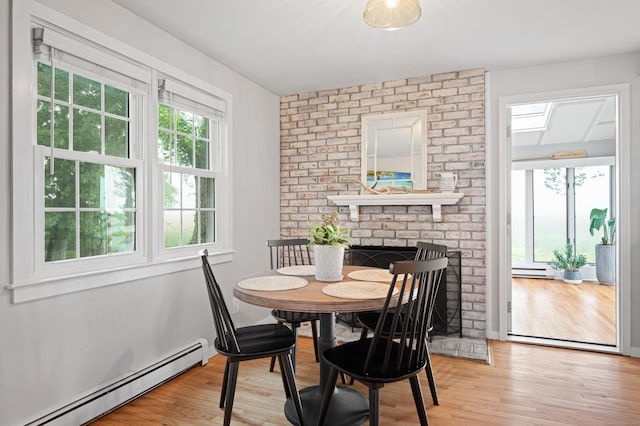 55 Cypress Rd, Old Saybrook, CT 06475 - dining space with baseboard heating, healthy amount of natural light, light wood-style floors, and a baseboard radiator