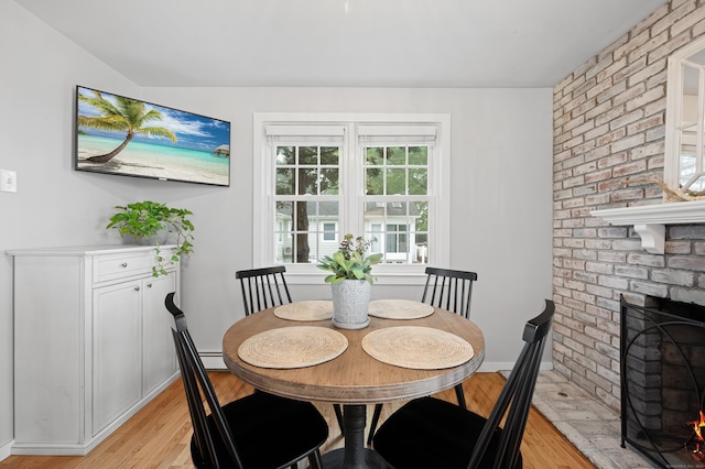 55 Cypress Rd, Old Saybrook, CT 06475 - dining space with light wood-style floors and a fireplace