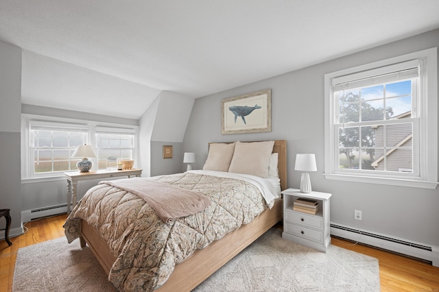 55 Cypress Rd, Old Saybrook, CT 06475 - bedroom featuring a baseboard heating unit, wood finished floors, and lofted ceiling