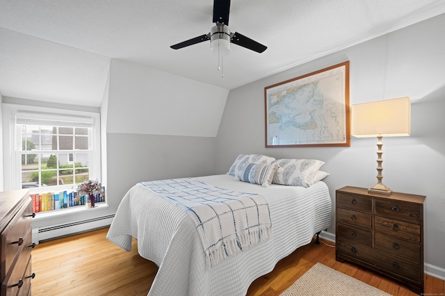 55 Cypress Rd, Old Saybrook, CT 06475 - bedroom featuring a baseboard heating unit, wood finished floors, a ceiling fan, and lofted ceiling