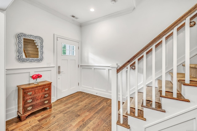 2180 Kings Hwy Unit 1, Fairfield, CT 06824 - entrance foyer featuring light wood-type flooring, stairway, crown molding, a decorative wall, and wainscoting