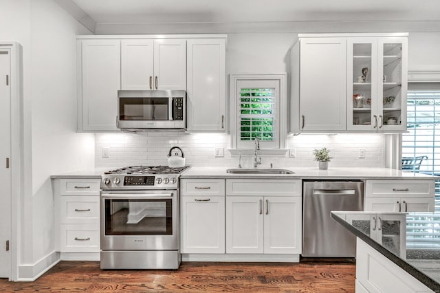 2180 Kings Hwy Unit 1, Fairfield, CT 06824 - kitchen with stainless steel appliances, a sink, white cabinetry, and decorative backsplash