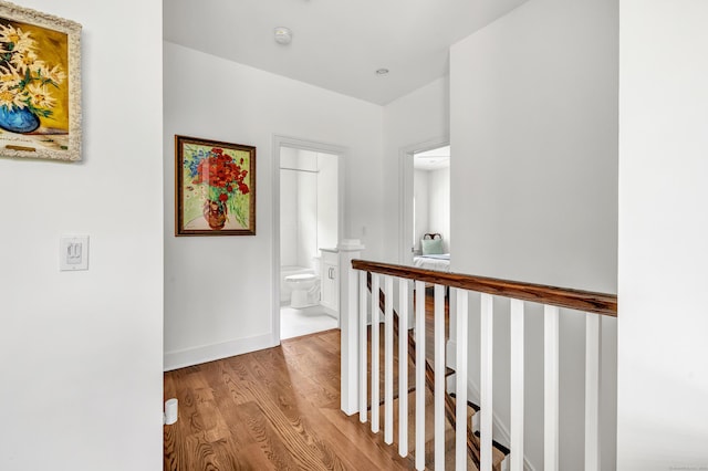 2180 Kings Hwy Unit 1, Fairfield, CT 06824 - hall featuring an upstairs landing, wood finished floors, and baseboards