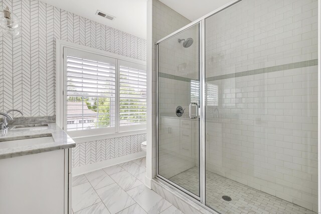 2180 Kings Hwy Unit 1, Fairfield, CT 06824 - bathroom with a stall shower, vanity, toilet, marble finish floors, and wallpapered walls