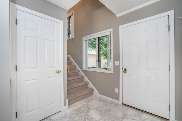 53 Bathcrescent Ln Unit 53, Bloomfield, CT 06002 - entrance foyer with light marble finish flooring, stairs, baseboards, and ornamental molding