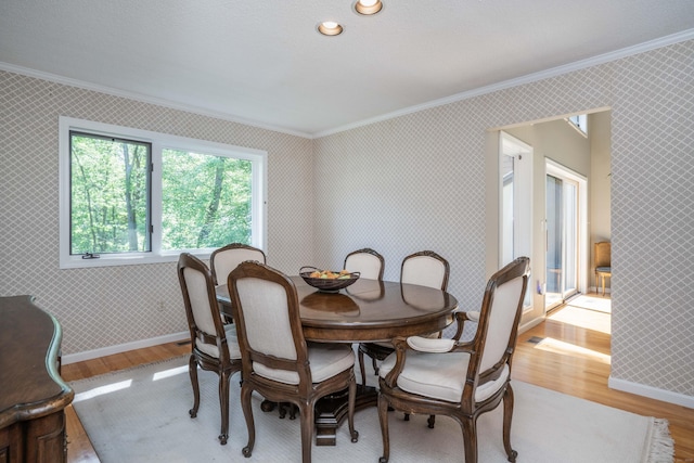 53 Bathcrescent Ln Unit 53, Bloomfield, CT 06002 - dining room with crown molding, light wood-style flooring, wallpapered walls, and baseboards