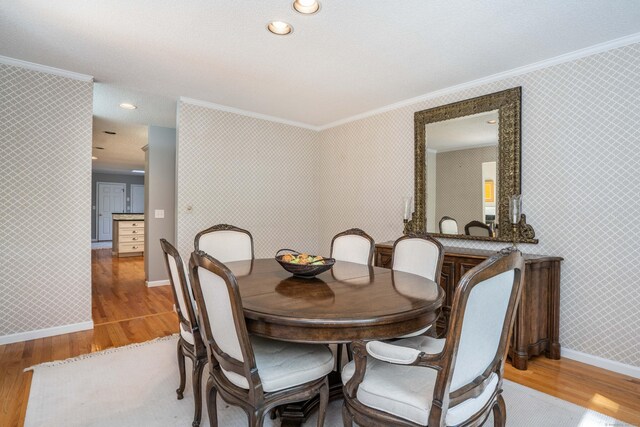 53 Bathcrescent Ln Unit 53, Bloomfield, CT 06002 - dining room featuring crown molding, light wood-style flooring, baseboards, and wallpapered walls