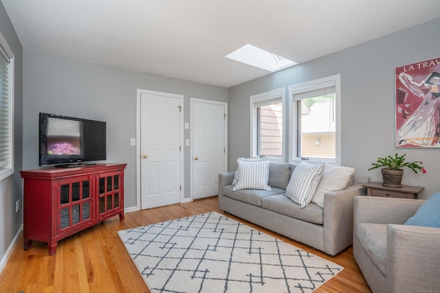 53 Bathcrescent Ln Unit 53, Bloomfield, CT 06002 - living room with a skylight, wood finished floors, and baseboards