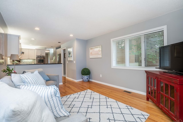 53 Bathcrescent Ln Unit 53, Bloomfield, CT 06002 - living room featuring light wood-style flooring, baseboards, and recessed lighting