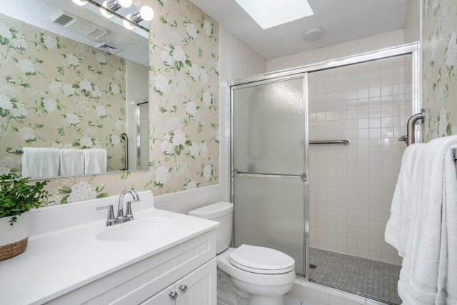 53 Bathcrescent Ln Unit 53, Bloomfield, CT 06002 - bathroom featuring wallpapered walls, a skylight, vanity, toilet, and a shower stall