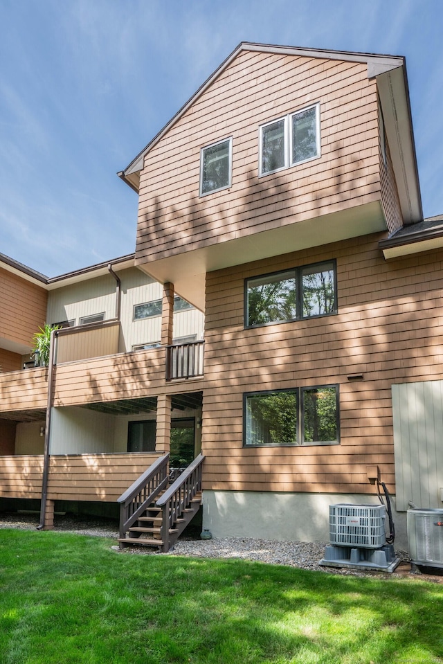 53 Bathcrescent Ln Unit 53, Bloomfield, CT 06002 - rear view of house featuring a lawn, central AC, a balcony, and stairway
