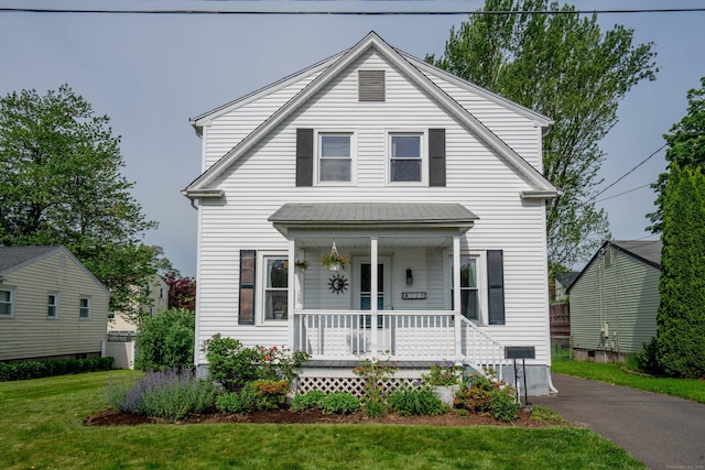 115 Ashland Ave, Newington, CT 06111 - view of front of home with covered porch and a front lawn