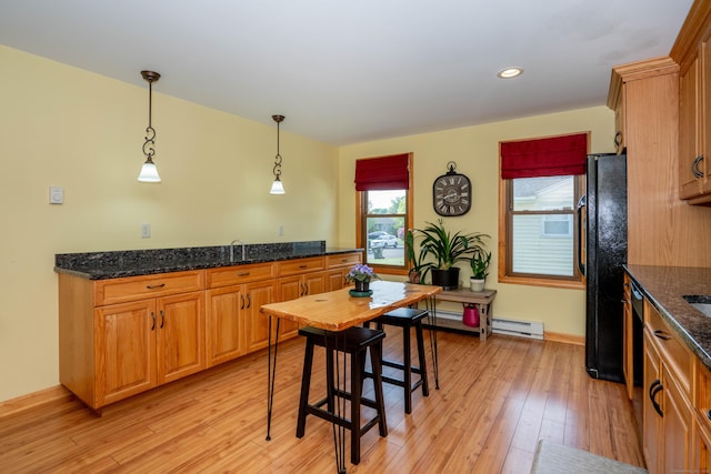 115 Ashland Ave, Newington, CT 06111 - kitchen featuring a baseboard radiator, light wood finished floors, freestanding refrigerator, hanging light fixtures, and dark stone counters