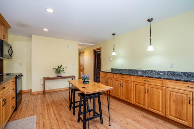 115 Ashland Ave, Newington, CT 06111 - kitchen featuring black appliances, light wood-style flooring, pendant lighting, recessed lighting, and dark stone countertops