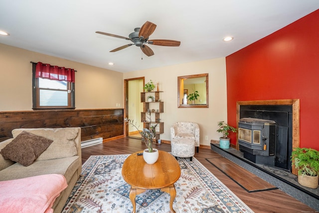 115 Ashland Ave, Newington, CT 06111 - living room featuring ceiling fan, recessed lighting, wood finished floors, a wood stove, and baseboard heating