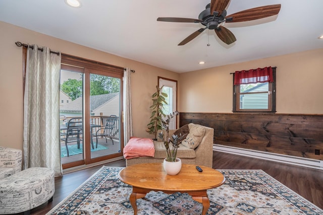 115 Ashland Ave, Newington, CT 06111 - living area with plenty of natural light, dark wood finished floors, a baseboard radiator, recessed lighting, and a wainscoted wall