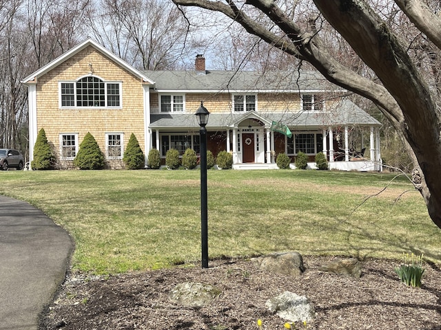 312 Towne House Rd, Fairfield, CT 06824 - view of front of home featuring a chimney, a front lawn, and a porch