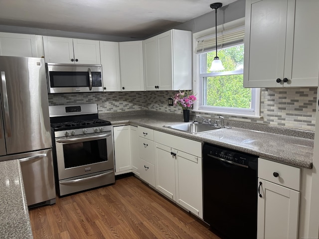 120 Wall St, Meriden, CT 06450 - kitchen featuring appliances with stainless steel finishes, a sink, white cabinets, and dark wood-style floors