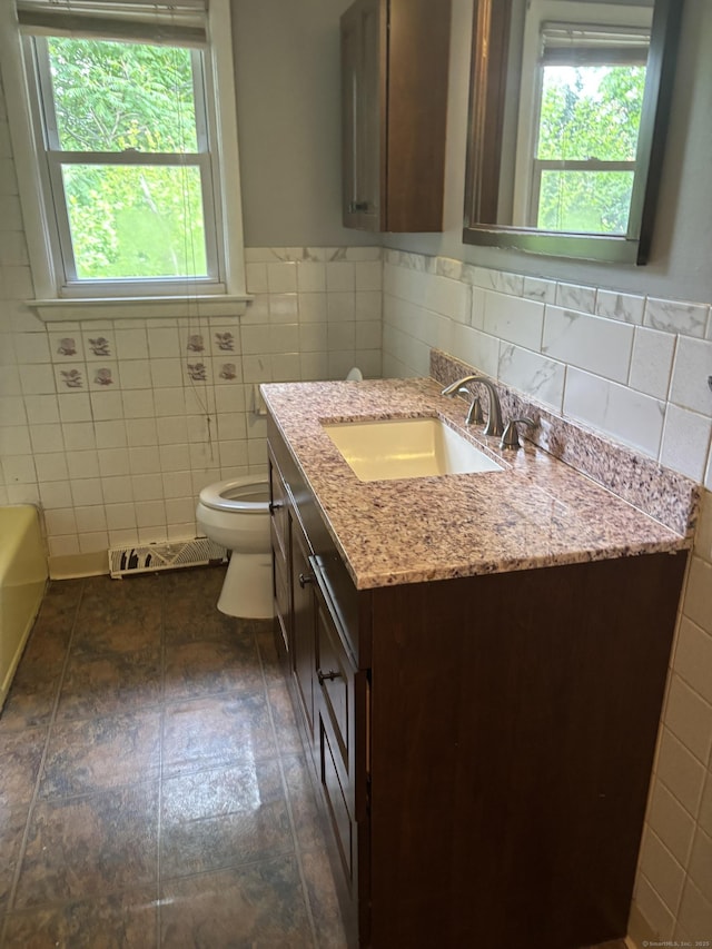 120 Wall St, Meriden, CT 06450 - full bathroom featuring tile walls, vanity, toilet, a bath, and a wainscoted wall