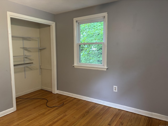 120 Wall St, Meriden, CT 06450 - unfurnished bedroom featuring baseboards, wood finished floors, and a closet