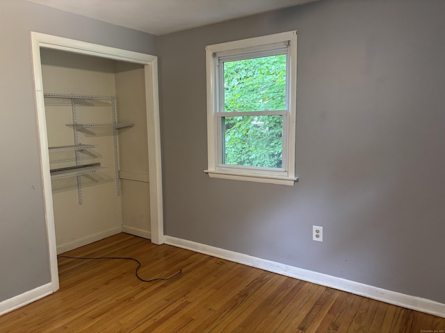 120 Wall St, Meriden, CT 06450 - unfurnished bedroom with baseboards, wood finished floors, and a closet