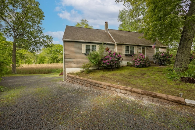 76 River St W, Old Saybrook, CT 06475 - view of front of home featuring a chimney and a front lawn