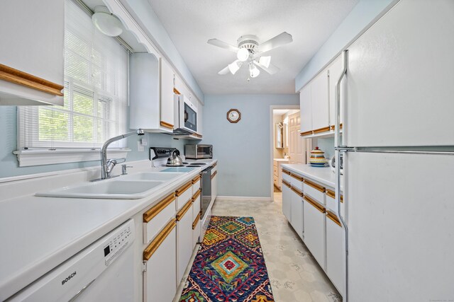 76 River St W, Old Saybrook, CT 06475 - kitchen with white appliances, light countertops, a ceiling fan, and white cabinets