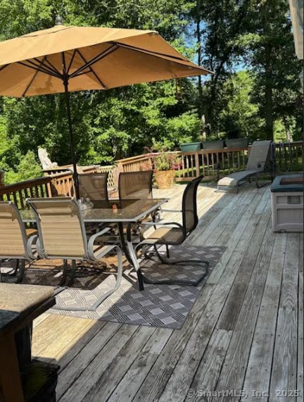 76 River St W, Old Saybrook, CT 06475 - wooden terrace with outdoor dining area and view of wooded area
