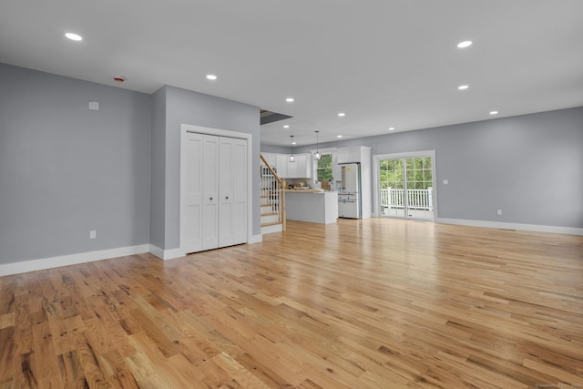 116 Joshua Town Rd, Waterbury, CT 06708 - unfurnished living room featuring stairway, light wood-type flooring, recessed lighting, and baseboards