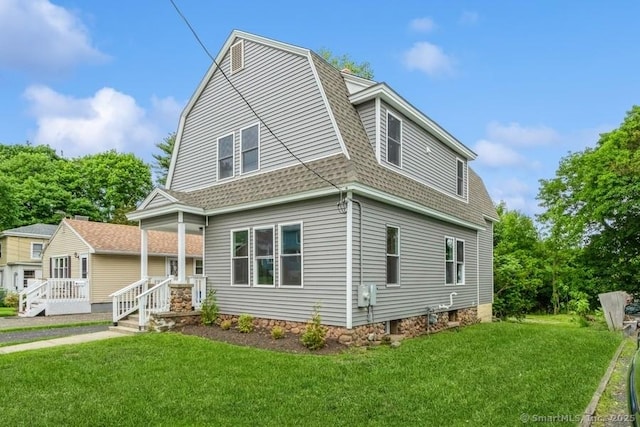 34 Wilbur Ave, Meriden, CT 06450 - colonial inspired home with a shingled roof, a gambrel roof, and a front lawn