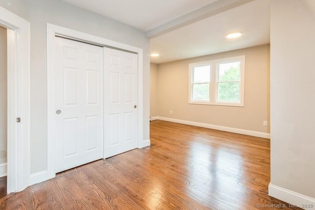 34 Wilbur Ave, Meriden, CT 06450 - unfurnished bedroom with wood finished floors, baseboards, a closet, and recessed lighting