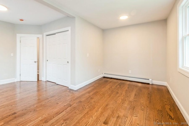 34 Wilbur Ave, Meriden, CT 06450 - unfurnished room with a baseboard heating unit, wood finished floors, and baseboards