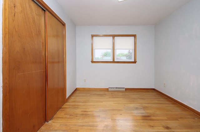 58 Wade St, West Haven, CT 06516 - unfurnished bedroom featuring light wood-style flooring, a closet, and baseboards