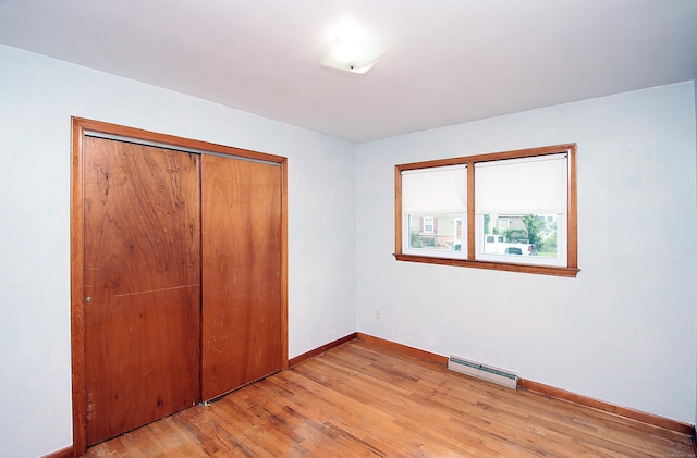 58 Wade St, West Haven, CT 06516 - unfurnished bedroom with baseboard heating, light wood finished floors, a closet, and baseboards