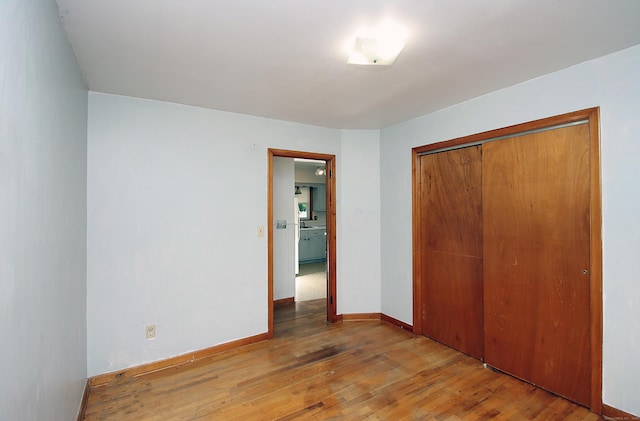 58 Wade St, West Haven, CT 06516 - unfurnished bedroom featuring wood finished floors, a closet, and baseboards