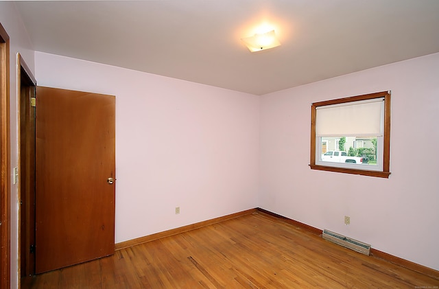 58 Wade St, West Haven, CT 06516 - spare room featuring a baseboard radiator, light wood-style flooring, and baseboards