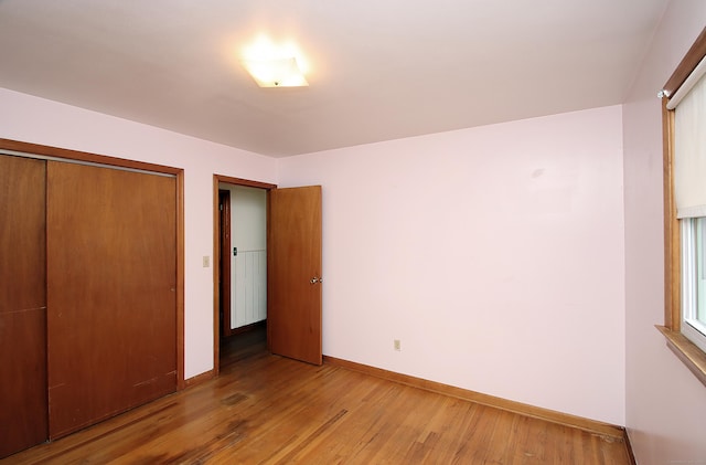 58 Wade St, West Haven, CT 06516 - unfurnished bedroom featuring light wood finished floors, baseboards, and a closet