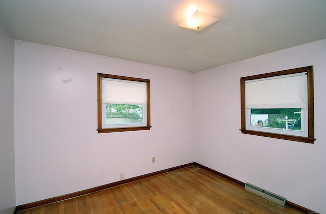 58 Wade St, West Haven, CT 06516 - spare room featuring a baseboard heating unit, wood finished floors, and baseboards