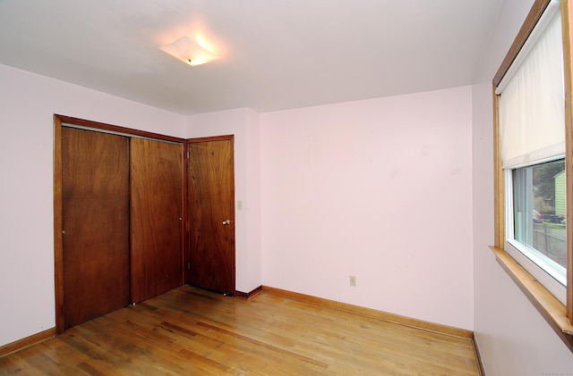 58 Wade St, West Haven, CT 06516 - unfurnished bedroom featuring light wood-type flooring, baseboards, and a closet