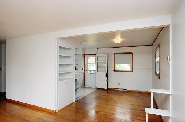 58 Wade St, West Haven, CT 06516 - spare room featuring light wood finished floors, baseboards, and a baseboard heating unit