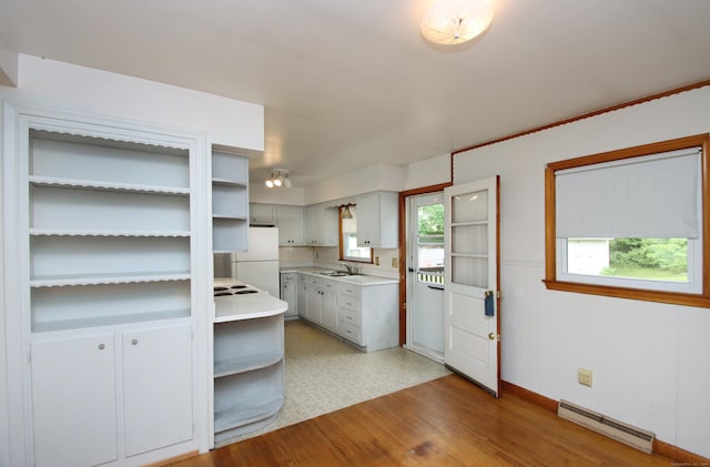 58 Wade St, West Haven, CT 06516 - kitchen featuring baseboard heating, freestanding refrigerator, a sink, light countertops, and open shelves