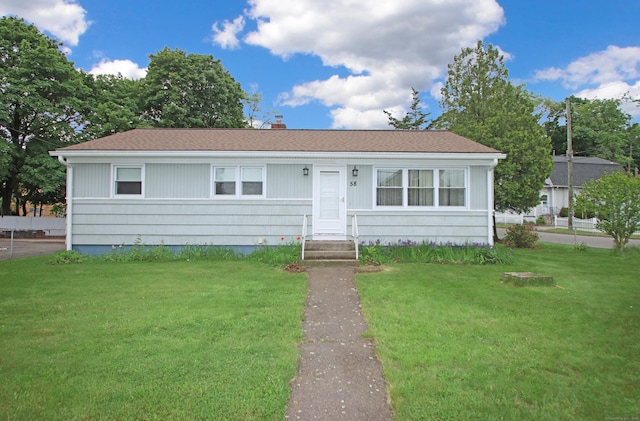 58 Wade St, West Haven, CT 06516 - view of front facade featuring a front yard and a chimney