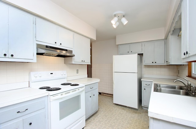 58 Wade St, West Haven, CT 06516 - kitchen with under cabinet range hood, white appliances, a sink, light flooring, and light countertops