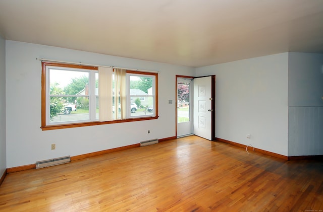58 Wade St, West Haven, CT 06516 - empty room featuring baseboard heating, light wood-type flooring, and baseboards