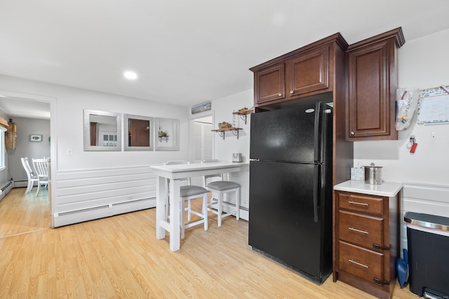 10 Ciccio Ct, Plainville, CT 06062 - kitchen with freestanding refrigerator, baseboard heating, light wood finished floors, light countertops, and recessed lighting