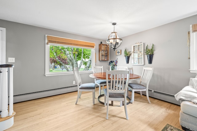 10 Ciccio Ct, Plainville, CT 06062 - dining space with a baseboard heating unit, a chandelier, and light wood-style flooring