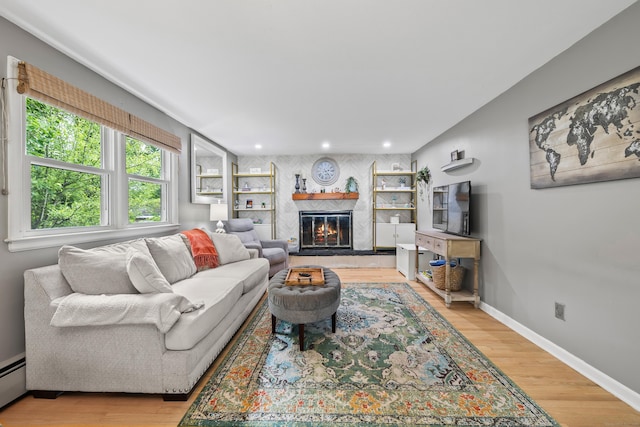 10 Ciccio Ct, Plainville, CT 06062 - living area with a baseboard radiator, recessed lighting, light wood finished floors, a fireplace, and baseboards