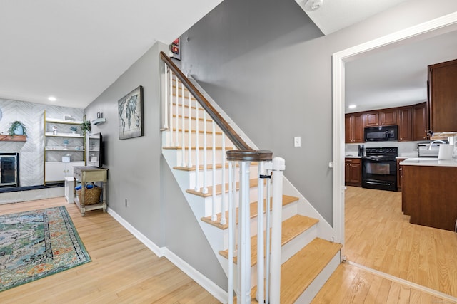 10 Ciccio Ct, Plainville, CT 06062 - stairs with wood finished floors, a glass covered fireplace, recessed lighting, and baseboards