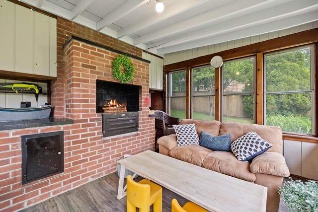 10 Ciccio Ct, Plainville, CT 06062 - living room with a lit fireplace, wood finished floors, and beam ceiling