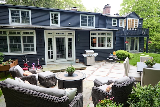 99 Cross Hwy, Redding, CT 06896 - back of property with an outdoor living space, a patio area, a chimney, and a balcony